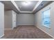 Bedroom featuring neutral walls, carpet flooring and tray ceiling detail at 1160 Faulkner Way, Jonesboro, GA 30238