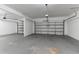 Spacious two-car garage featuring two automatic doors and sealed concrete flooring at 1160 Faulkner Way, Jonesboro, GA 30238