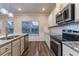 Modern kitchen featuring granite countertops, stainless steel appliances, and wood flooring at 1160 Faulkner Way, Jonesboro, GA 30238