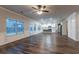 Spacious living room with hardwood floors, a ceiling fan, large windows, and an open floor plan at 1160 Faulkner Way, Jonesboro, GA 30238