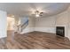 Large open living room with fireplace, staircase, and wood-look floors at 1160 Faulkner Way, Jonesboro, GA 30238