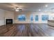 Bright living room features a fireplace, dark hardwood floors, and large windows with natural light at 1160 Faulkner Way, Jonesboro, GA 30238