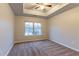 Bedroom featuring plush carpet, a ceiling fan, tray ceiling, and a window at 1160 Faulkner Way, Jonesboro, GA 30238