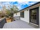 Back deck with access to a door, overlooking the backyard, with lush greenery in the background at 2954 Lighthouse Ct, Acworth, GA 30101