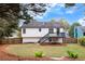 Spacious fenced backyard featuring a deck, grassy area, and pine straw landscaping at 2954 Lighthouse Ct, Acworth, GA 30101