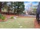 Lush backyard with mature trees, a stepping stone path, and a wooden fence at 2954 Lighthouse Ct, Acworth, GA 30101