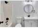 Well-lit bathroom with a shower-tub combo, modern vanity, updated fixtures, and a round mirror at 2954 Lighthouse Ct, Acworth, GA 30101