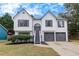 Charming two-story home featuring a manicured lawn and an attached two-car garage at 2954 Lighthouse Ct, Acworth, GA 30101