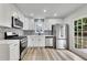 Well-equipped kitchen with white cabinets, stainless appliances, and modern countertops at 2954 Lighthouse Ct, Acworth, GA 30101