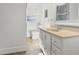 Bright bathroom with white cabinets, a sink, and a commode at 4183 Hideaway Dr, Tucker, GA 30084