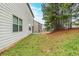 Side of home with a window and doors leading to backyard; view of back yard with neighbor at 450 Lake Ridge Ln, Fairburn, GA 30213