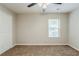 This bedroom has neutral walls, carpet flooring, a ceiling fan, and a window for natural light at 450 Lake Ridge Ln, Fairburn, GA 30213