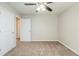 This neutral colored bedroom includes carpet flooring, ceiling fan, and a closet at 450 Lake Ridge Ln, Fairburn, GA 30213