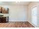 Dining area with hardwood floors, brown cabinets, and a view to the exterior through a window at 450 Lake Ridge Ln, Fairburn, GA 30213
