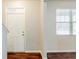 Inviting entryway featuring a white front door, hardwood floors, and a window for natural light at 450 Lake Ridge Ln, Fairburn, GA 30213