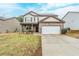 Charming two-story home with brick accents, a two-car garage, and a well-maintained front yard at 450 Lake Ridge Ln, Fairburn, GA 30213