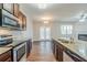 Bright kitchen featuring stainless steel appliances, granite countertops, and an open view to the living area at 450 Lake Ridge Ln, Fairburn, GA 30213