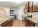 Modern kitchen with stainless steel appliances, granite countertops, and rich brown cabinetry at 450 Lake Ridge Ln, Fairburn, GA 30213