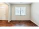 Hardwood floors, white walls, bright window, and white trim create an inviting living room at 450 Lake Ridge Ln, Fairburn, GA 30213