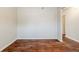 Open-concept room features hardwood floors, white trim, a large window, and neutral walls at 450 Lake Ridge Ln, Fairburn, GA 30213