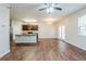 Open-concept kitchen and living area with wood floors and stainless steel appliances at 450 Lake Ridge Ln, Fairburn, GA 30213