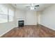 Cozy living room with hardwood floors, a fireplace, and ample natural light from a large window at 450 Lake Ridge Ln, Fairburn, GA 30213