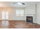 Bright living room features wood floors, a fireplace, and access to the outdoors at 450 Lake Ridge Ln, Fairburn, GA 30213