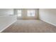 Loft area with neutral carpet and two large windows at 450 Lake Ridge Ln, Fairburn, GA 30213