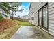 Back patio with double doors, small lawn, and partially fenced-in backyard at 450 Lake Ridge Ln, Fairburn, GA 30213