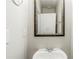 Powder room with a pedestal sink and decorative mirror at 450 Lake Ridge Ln, Fairburn, GA 30213