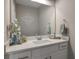 Modern powder room featuring a white vanity with elegant hardware, a large mirror, and stylish decor at 531 Eagles Nest Cir, Auburn, GA 30011