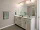 Well-lit bathroom with a dual sink vanity, a large mirror, and neutral paint colors at 531 Eagles Nest Cir, Auburn, GA 30011