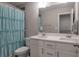 Bathroom featuring a double vanity, shower with a blue curtain, and a large mirror at 531 Eagles Nest Cir, Auburn, GA 30011