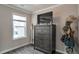 A bright bedroom with light grey walls, wood-look floors, a window and an antique dresser and mirror at 531 Eagles Nest Cir, Auburn, GA 30011