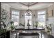 Elegant dining area with wainscoting, modern lighting, and lots of natural light from three windows at 531 Eagles Nest Cir, Auburn, GA 30011
