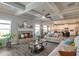 Open living room with a cozy fireplace, coffered ceilings, and a view of the modern kitchen at 531 Eagles Nest Cir, Auburn, GA 30011