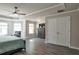 Comfortable main bedroom with a tray ceiling, ceiling fan, lots of natural light, and wood-look floors at 531 Eagles Nest Cir, Auburn, GA 30011