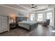 Spacious main bedroom with a tray ceiling, ceiling fan, lots of natural light, and wood-look floors at 531 Eagles Nest Cir, Auburn, GA 30011