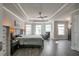 This bright main bedroom includes wood-look floors, a ceiling fan, large windows and a tray ceiling at 531 Eagles Nest Cir, Auburn, GA 30011