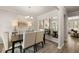 Formal dining area featuring modern decor, hardwood floors, and ample natural light from adjacent living spaces at 590 River Garden Dr, Atlanta, GA 30354