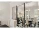 Dining room view with modern chandelier, table with seating, and decorative mirrored wall at 590 River Garden Dr, Atlanta, GA 30354