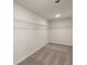 An empty walk-in closet with carpet and wire shelving, ready for your personal organization at 590 River Garden Dr, Atlanta, GA 30354