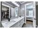 Bathroom featuring double sinks with white cabinets and granite countertops, as well as access to a closet and bedroom at 783 Blackberry Trl, Lawrenceville, GA 30043