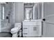 A bright bathroom features a white vanity, and a glass-enclosed shower with marble tiling at 783 Blackberry Trl, Lawrenceville, GA 30043
