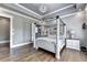 This primary bedroom features tray ceiling, chandelier, and a four-poster bed at 783 Blackberry Trl, Lawrenceville, GA 30043