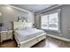 A well lit bedroom offers a large window, hardwood floors, and ample natural light at 783 Blackberry Trl, Lawrenceville, GA 30043