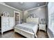 A neutral bedroom offers hardwood floors, ample lighting, and a view of the ensuite at 783 Blackberry Trl, Lawrenceville, GA 30043