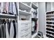 This walk-in closet features custom shelving for hanging clothes, folded clothing, and shoes at 783 Blackberry Trl, Lawrenceville, GA 30043
