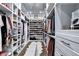 This walk-in closet features custom shelving for hanging clothes, folded clothing, and shoes at 783 Blackberry Trl, Lawrenceville, GA 30043