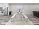 Dining area featuring a wooden table and benches, stainless refrigerator, and hardwood flooring at 783 Blackberry Trl, Lawrenceville, GA 30043